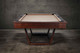 American-made Doc & Holliday Zoey in short wide profile; level stance, precise rail geometry, and maple grain texture read clearly—professional playfield presence in a modern lifestyle scene. American-made Doc & Holliday Zoey in short wide profile; level stance, precise rail geometry, and maple grain texture read clearly—professional playfield presence in a modern lifestyle scene.